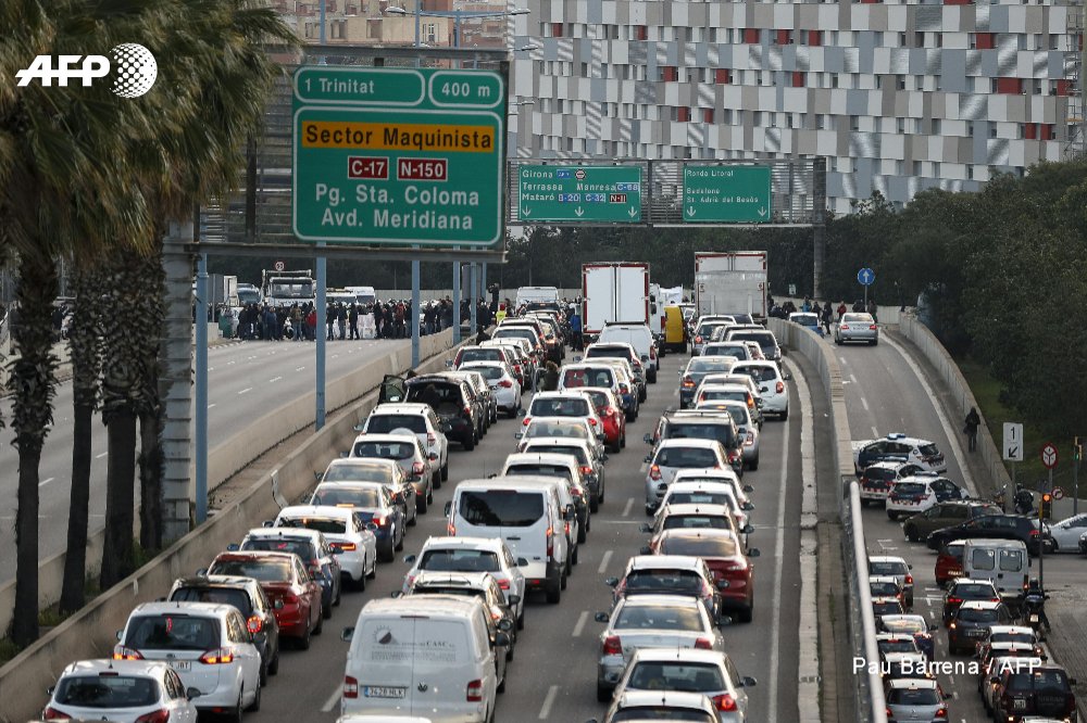 Protesters block roads and train tracks in Catalonia as part of a region-wide strike called by pro-independence union