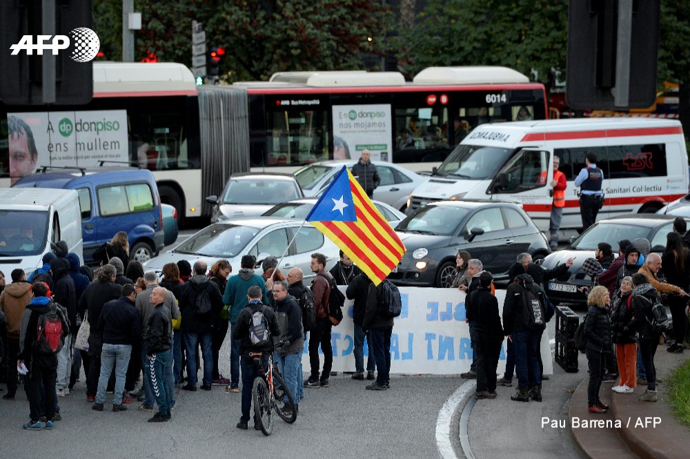 Protesters block roads and train tracks in Catalonia as part of a region-wide strike called by pro-independence union