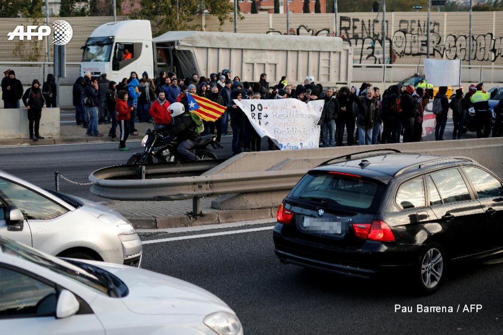 Protesters block roads and train tracks in Catalonia as part of a region-wide strike called by pro-independence union